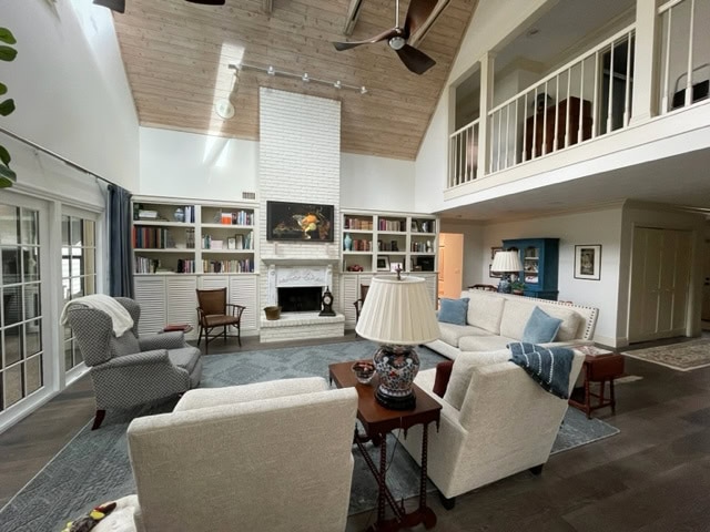 Sherwin Williams Antique White trim, Alabaster warm white walls, vaulted or cathedral ceiling, painted brick fireplace, cream cabinets built ins