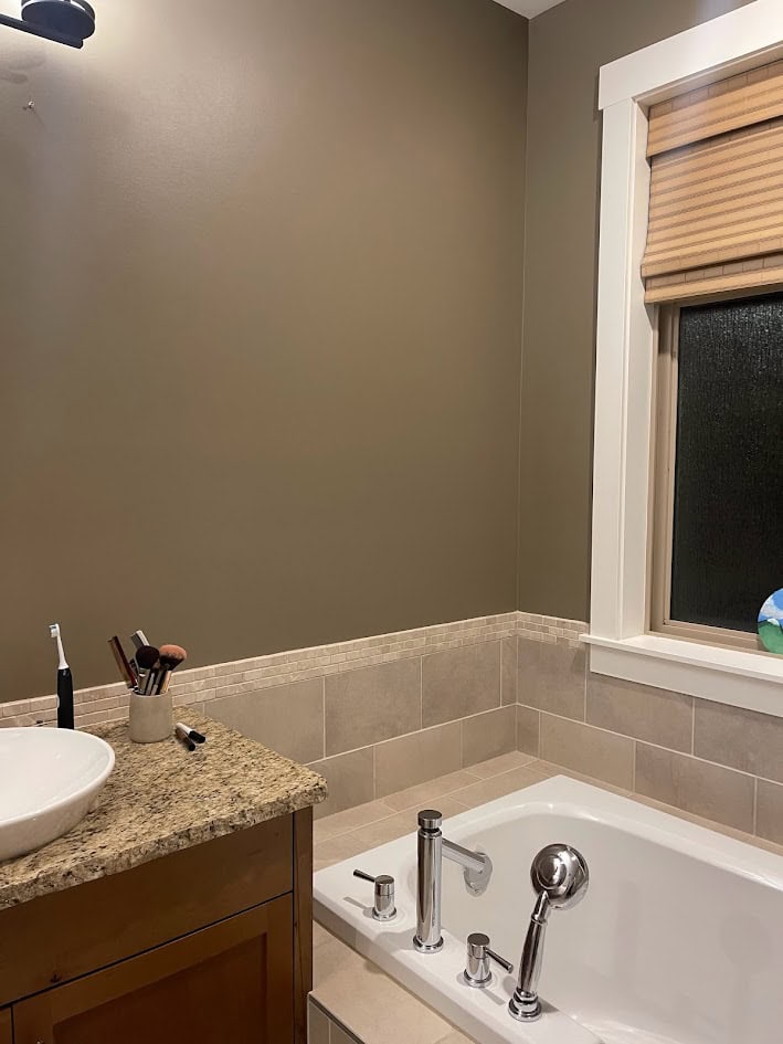 2000s tuscan style bathroom with travertine, beige tile, granite countertop, St. Cecelia, maple or hickory wood cabinets, beige tan windows