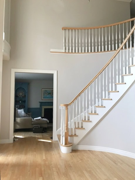 Benjamin Moore Collingwood, best warm gray paint color, purple tones, light oak wood floor, curved 1990s staircase