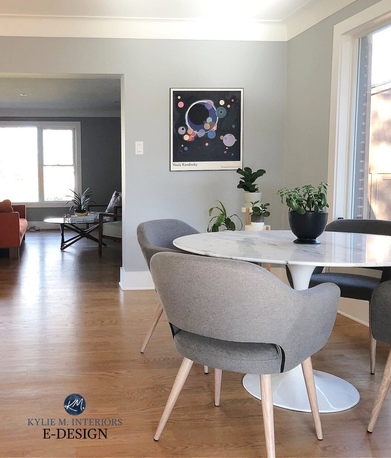 Benjamin Moore Eternity, gray paint color with cool undertones, modern contemporary style marble dining table, gray chairs, light wood laminate flooring