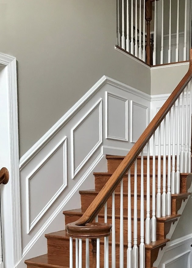 Benjamin Moore Revere Pewter, staircase with red toned oak flooring, white and wood railing, wainscoting. Kylie M Interiors Edesign, online consulting blogger (1)