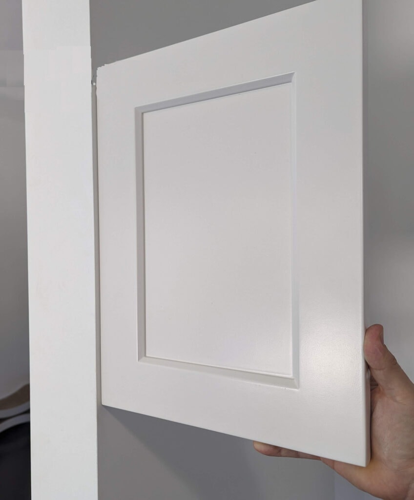 Benjamin Moore Silver Satin, off white warm gray on painted cabinet door with Chantilly Lace walls - violet undertone