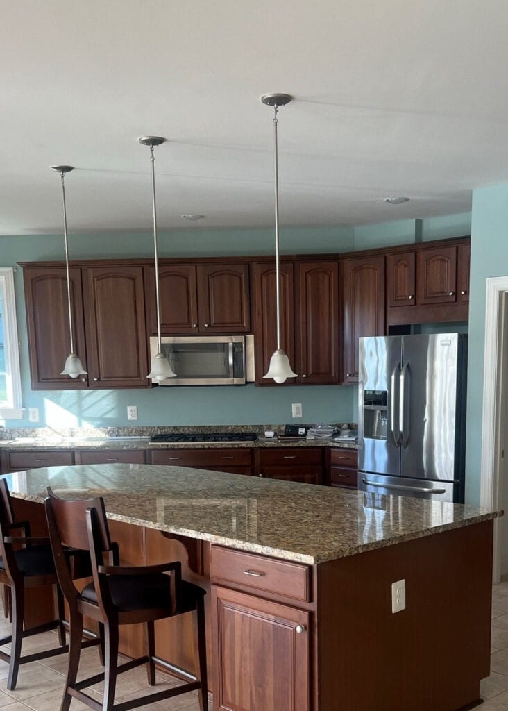 Cherry kitchen cabinets before painting, beige tile floor
