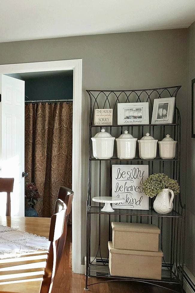Country farmhouse style dining room, warm wood floor and furniture. Kylie M Interiors E-design, online paint color consulting. Sherwin Williams Dorian Gray (1)