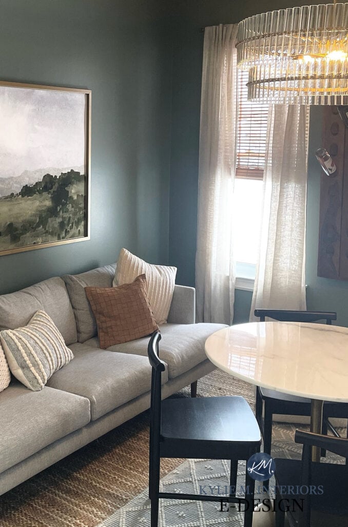 Sherwin Williams Retreat, best dark shade of green paint color in moody, cozy den with crystal glass chandelier and marble table top.