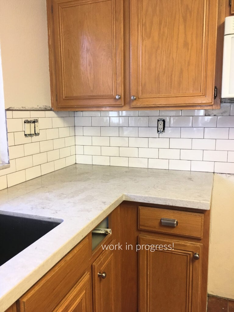 oak 1990s or 1980 kitchen cabinets, white subway tile backsplash, Caesarstone Bianco Drift light gray quartz countertop, update ideas with Kylie M