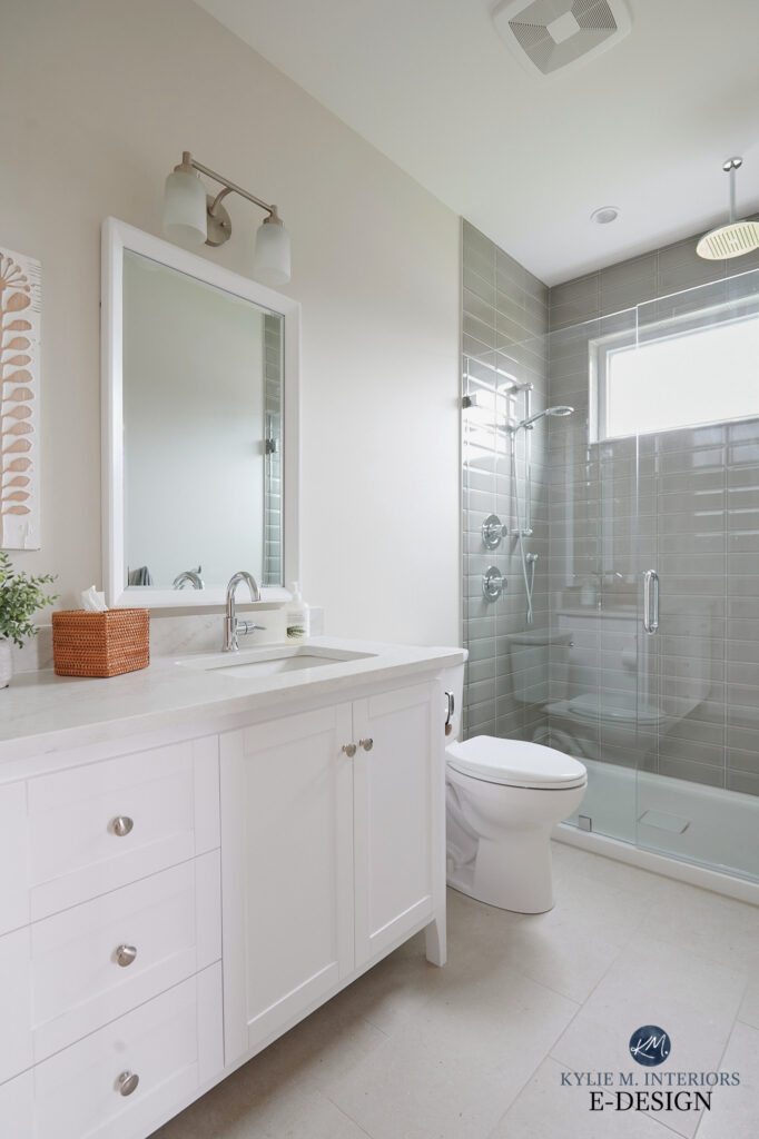 ensuite bathroom, double white painted vanity, omnia quartz countertop, green gray subway tile walk in shower, acrylic base, Sherwin Williams Aesthetic White beige on walls, beige tile floor.
