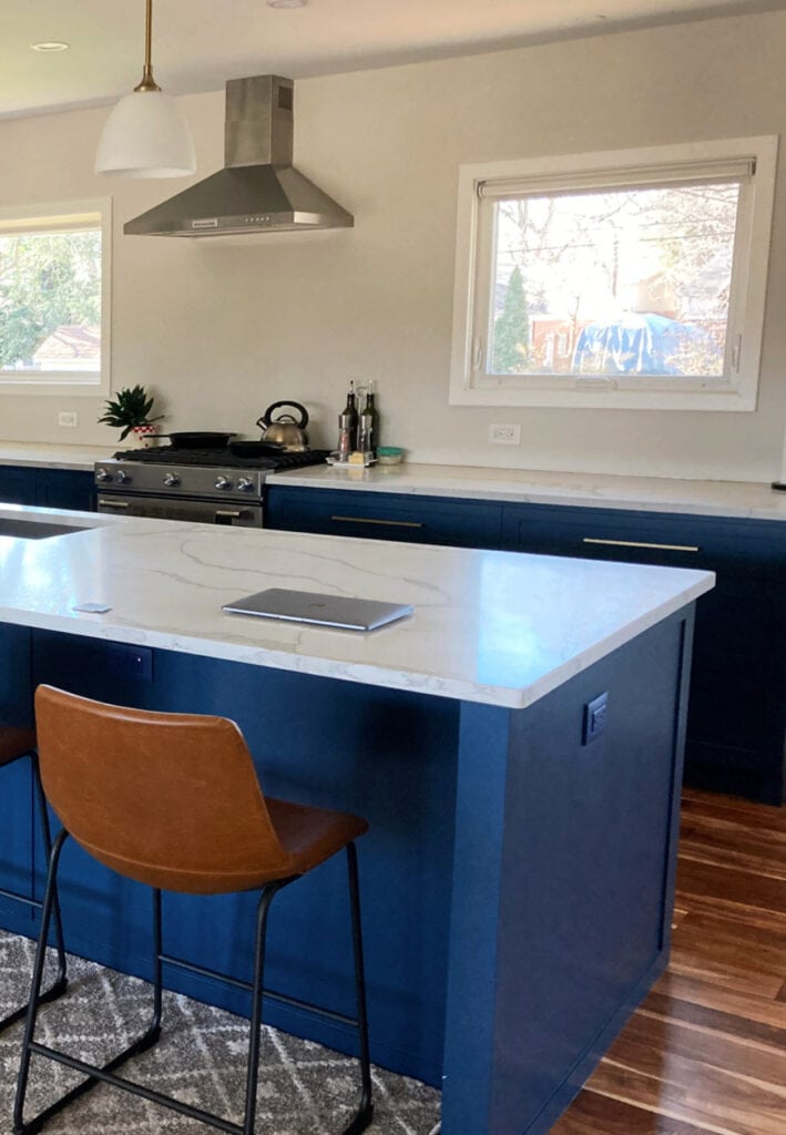 gentlemans gray painted kitchen island and lower cabinets, white marble look quasrtz countertop, stainless steel appliacnces, gold hardware. (1)