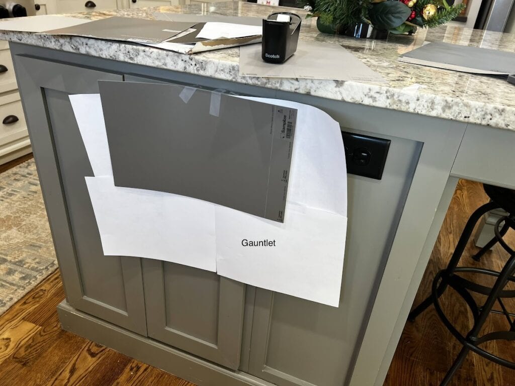 Sherwin Williams Gauntlet Gray dark gray paint color on kitchen island with granite countertops. Original color is Benjamin Moore Chelsea Gray.