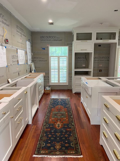 Benjamin Moore China White, best warm off-white paint color, darkened, on painted kitchen cabinets, gold hardware, red exotic wood flooring (2)