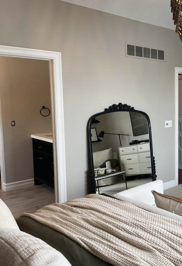 Revere Pewter transitional bedroom, warm gray, white trim, sofa at end of beige, beige taupe carpet. Kylie M client photo edesign expert