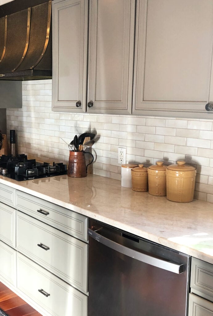 Taj Mahal warm beige quartzite countertops, subway tile, greige, warm gray
