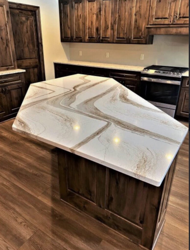 brittanica warm white quartz countertop, dark wood cabinets, wood floor, stainless steel. Kitchen update ideas with dark wood