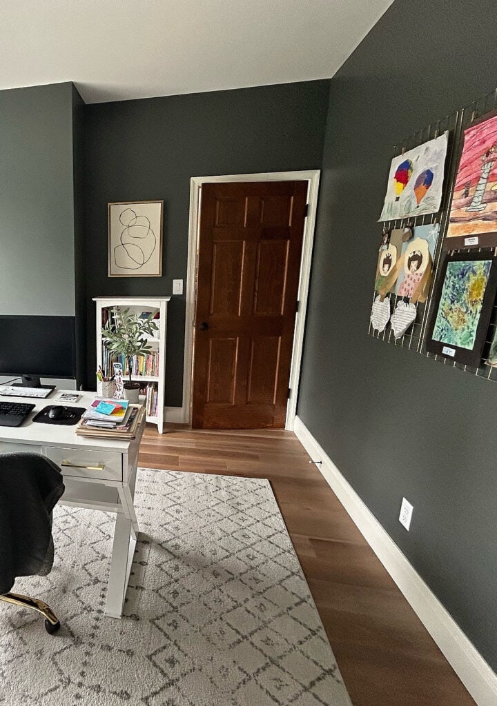 home office, with a dark wood door, creamy white trim is Sherwin Williams Pearly White, Grizzle Gray, dark green color on the walls