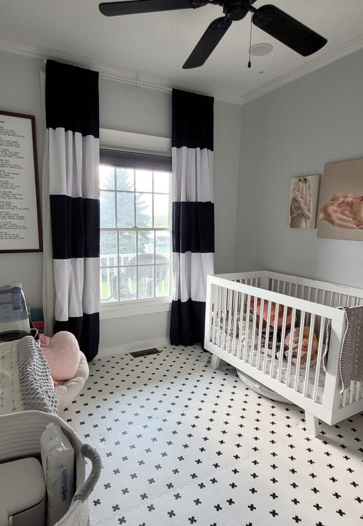 Baby nursery or room for boy or girl, white cross foam click together floor, Sherwin Williams Rock Candy gray paint color onw alls, white trim and ceiling, drapes, and white crib