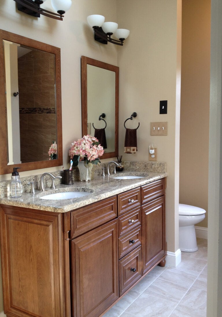 Behr Mushroom Bisque popular beige paint color in bathroom, beige tile floor, beige granite countertop, maple orange vanity, oil rubbed bronze fixtures, warm neutral
