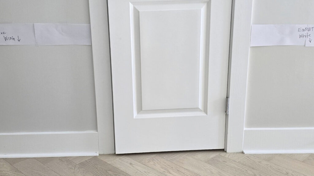 Behr Ultra Pure White trim with Benjamin Moore Dove Wing and Sherwin williams Egret White samples. Whitewashed herringbone oak floor
