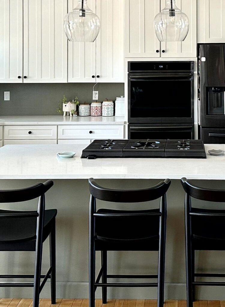 Benjamin Moore Antique Pewter painted kitchen island cabinet with white and dark stainless steel, white quartz countertop
