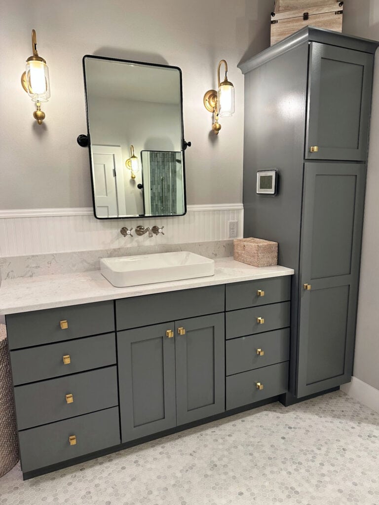 Benjamin Moore Charcoal Slate dark gray painted vanity, marble hexagon small tile floor, On the Rocks wall color, Chantilly Lace beadboard backsplash white quartz.