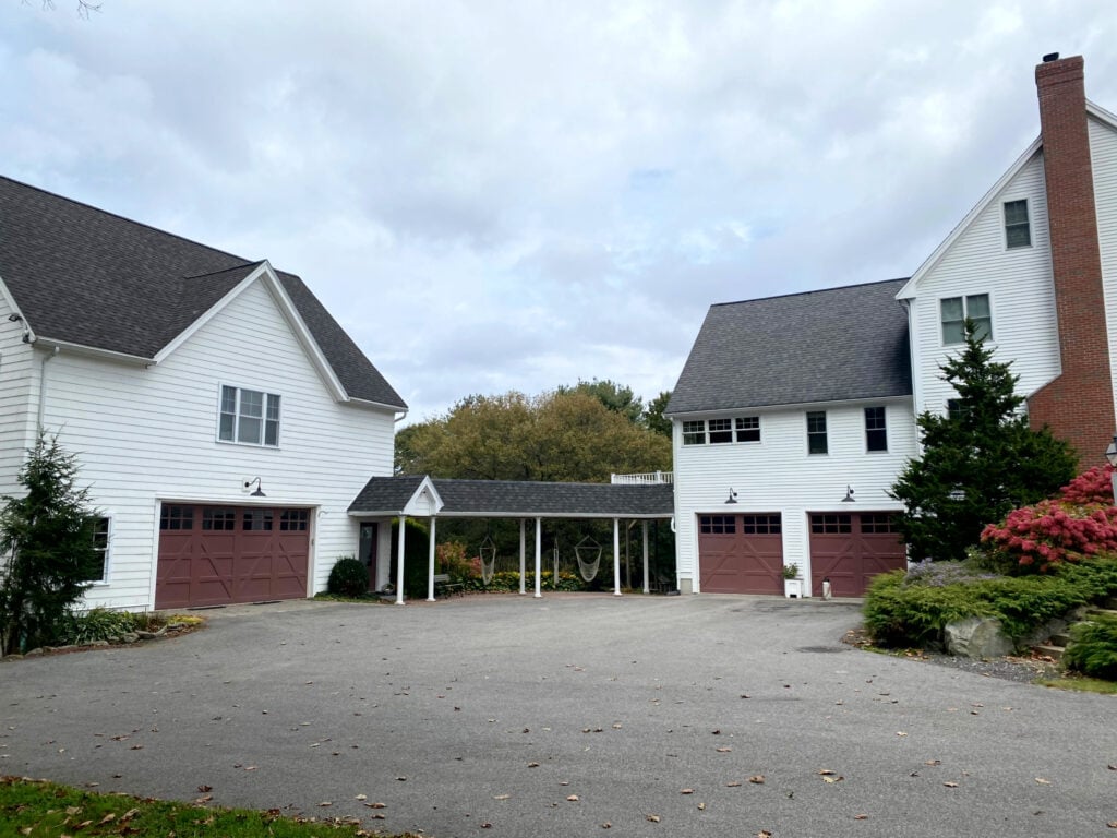 Benjamin Moore Hodley Red, burgundy maroon painted garage doors, Arbor Coat White 64001 exterior solid stain on siding, brick chimney