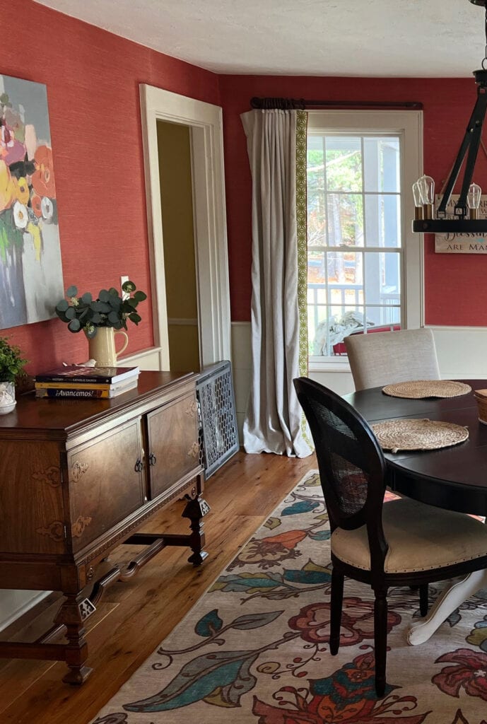 Benjamin Moore Manchester Tan light off-white painted trim, red wallpaper, dining room, area rug, wood floor