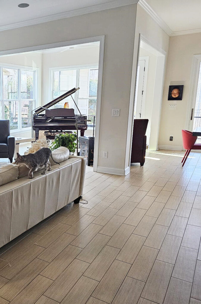 Benjamin Moore Maritime White, warm off-white paint color, beige wood look tile floor, baby grand piano, north west light