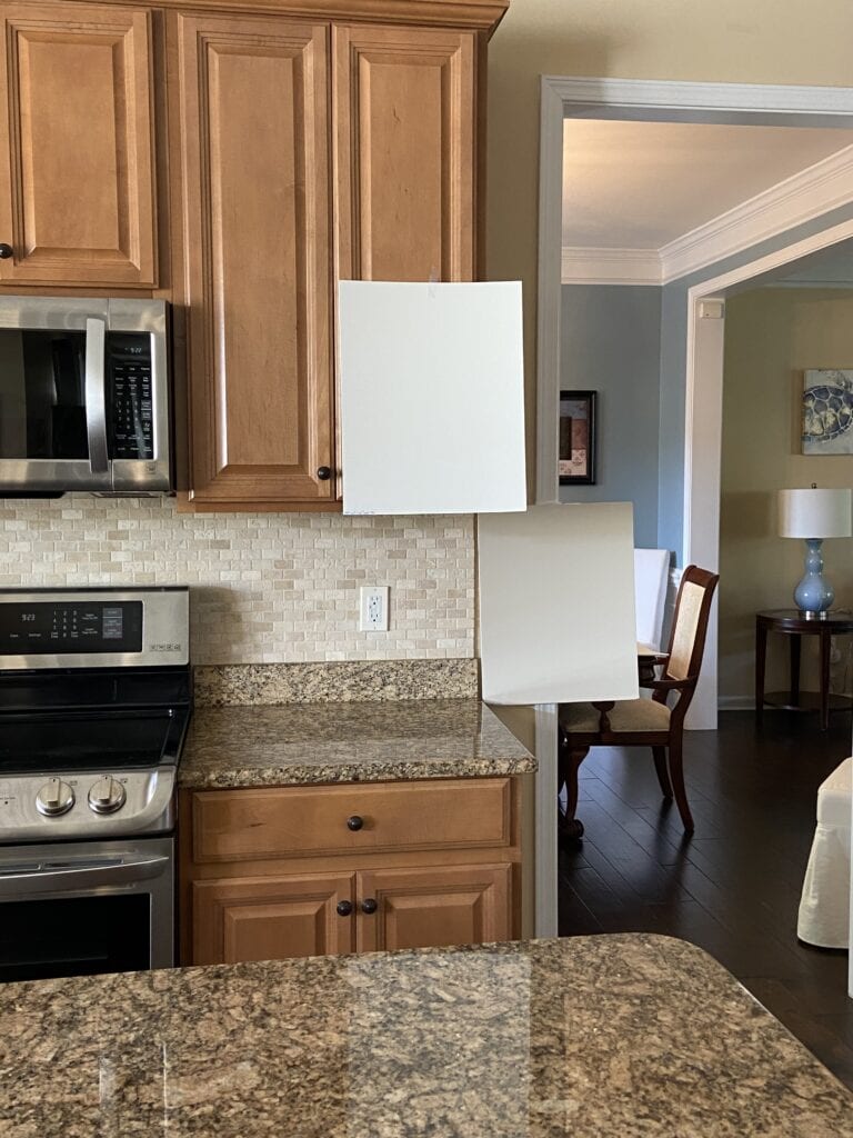Benjamin Moore Muslin, warm neutral beige paint color, travertine tile backsplash, granite countertops, orange maple wood kitchen cabinets