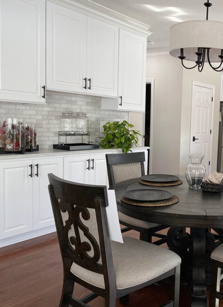 Benjamin Moore Natural Cream paint color on walls, marble subway tile backsplash, off-white gray quartz countertop