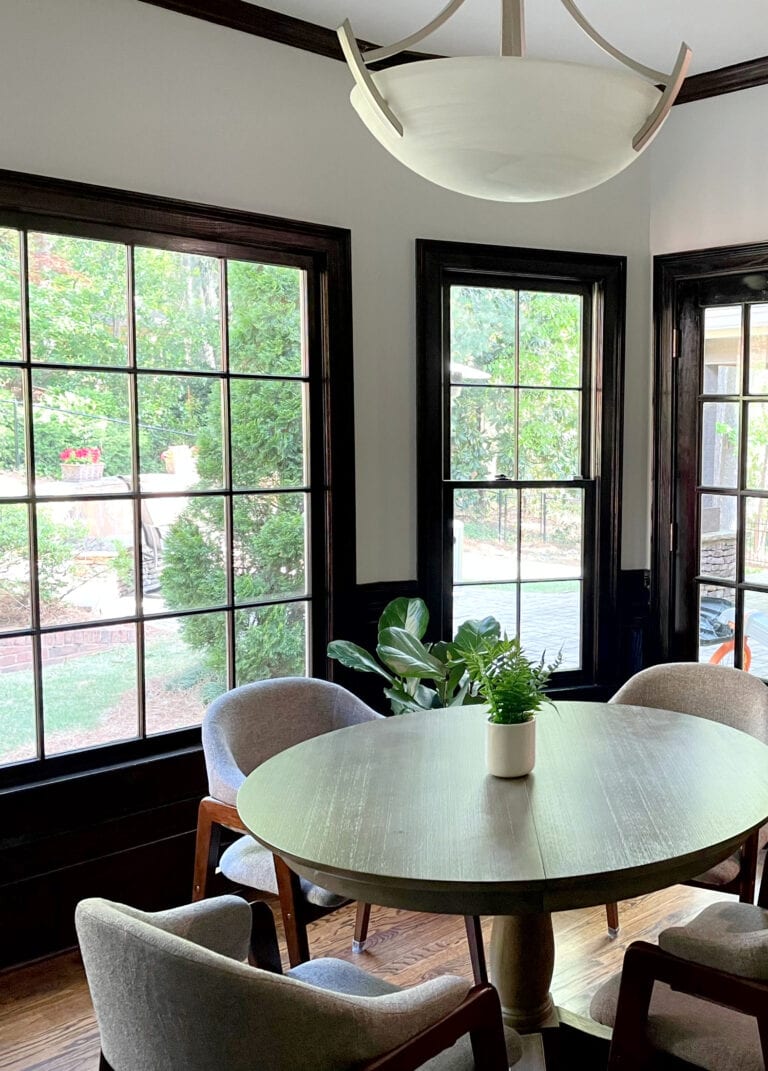 Benjamin Moore Paper White, dark stained wood trim, wainscoting, crowm molding, eating nook with round table