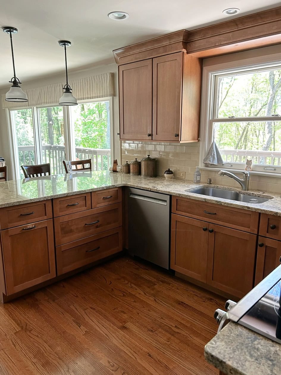 Benjamin Moore Revere Pewter walls, Sherwin Alabaster trim, maple orange stian cabinets, Niagara granite countertop, beige subway tile backsplash, oak floor, peninsula, pendant lights