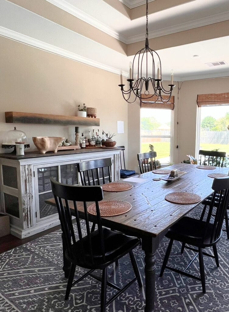 Dining room, warm shade of beige, dark wood floor, farmhouse dining table, bamboo shades, tray ceiling Sherwin Williams Kilim Beige on walls