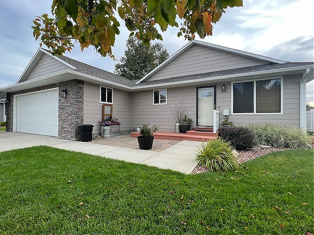 Exterior siding painted Sherwin Williams Perfect Greige, asphalt roof, Pure White trim, and garage door