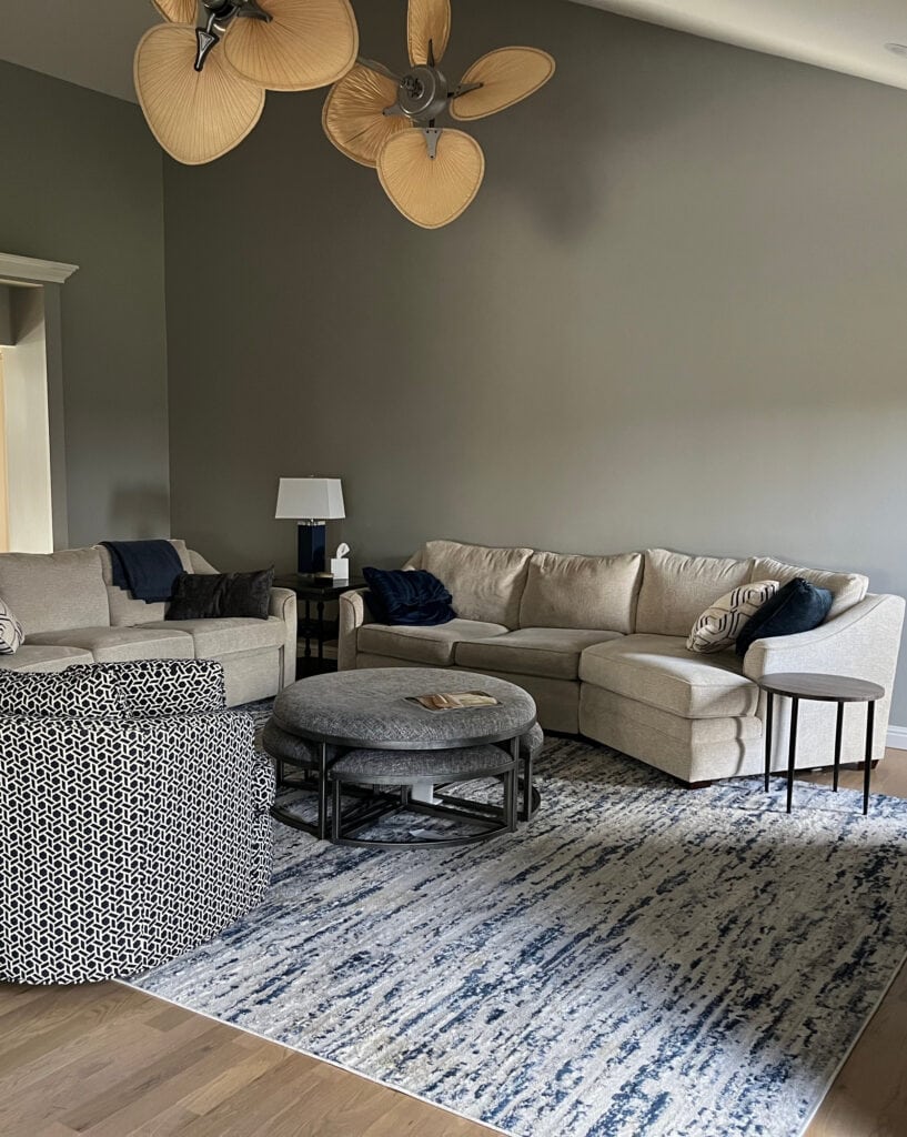 Family room with medium gray walls, Sherwin Williams Gray Clouds, beige furniture, wood floor, vaulted ceiling, dark room low light