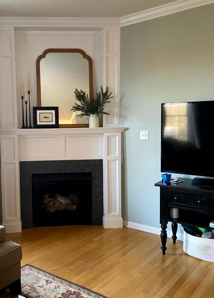 Gas fireplace, dark gray slate tile surround, white mantel surround, Silver Sage Restoration Hardware paint color, oak strip golden flooring