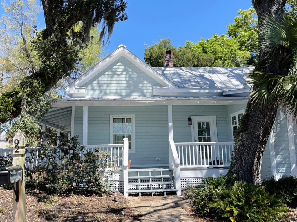 Gray exterior with blue undertones, painted siding, gray, silver metal roof, white trim and front porch, Benjamin Moore White OC 151
