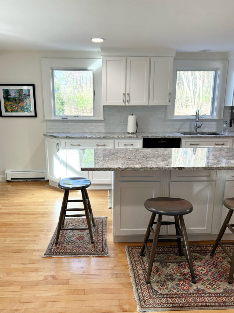 Maple wood floor, Benjamin Moore White Dove cabinets walls, trims, gray and white granite countertop, cool toned subway tile backsplash, nickel hardware. Kylie M, painted kitchen cabinets