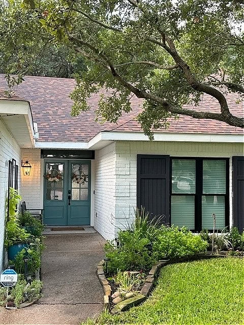 Romabio Avorio White brick exterior, Iron Ore shutters, Sherwin Williams Riverway painted front door, taupe, violet, orange asphalt roof