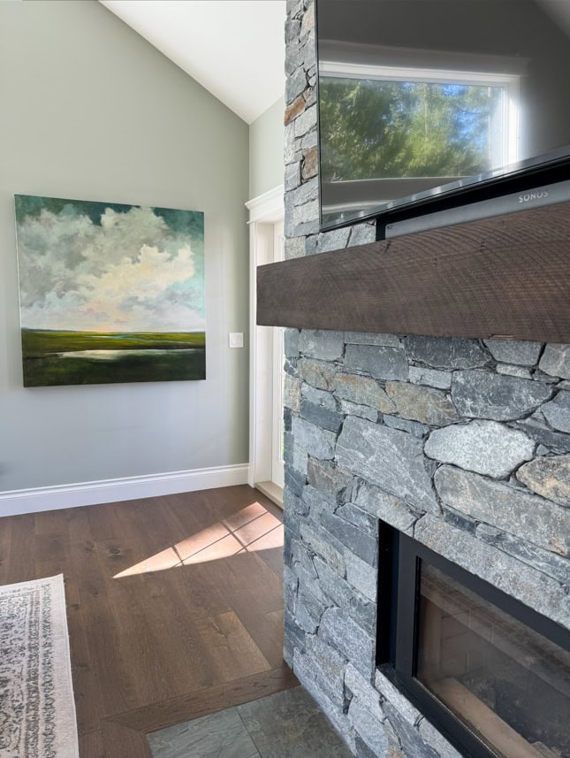 Sherwin Williams Austere Gray, green gray paint color on walls, Pure White trim and ceiling, k2 natural stone fireplace, wood burning, dark wood mantel and tv, wood floor, KYlie M