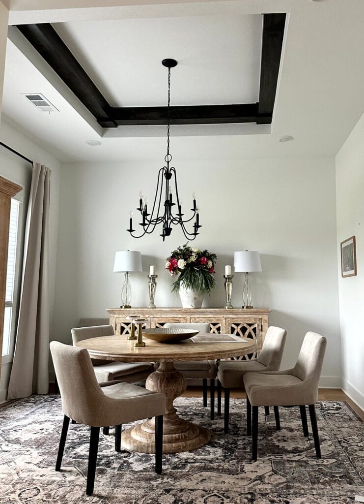 Sherwin Williams Extra White, north facing dining room, tray ceiling with wood beam detail, round table and upholstered chairs
