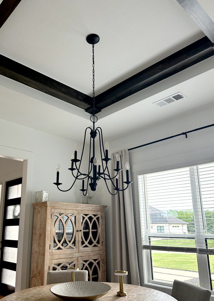 Sherwin Williams Extra White tray ceiling, walls, trims, wood detail beams in ceiling, chandelier