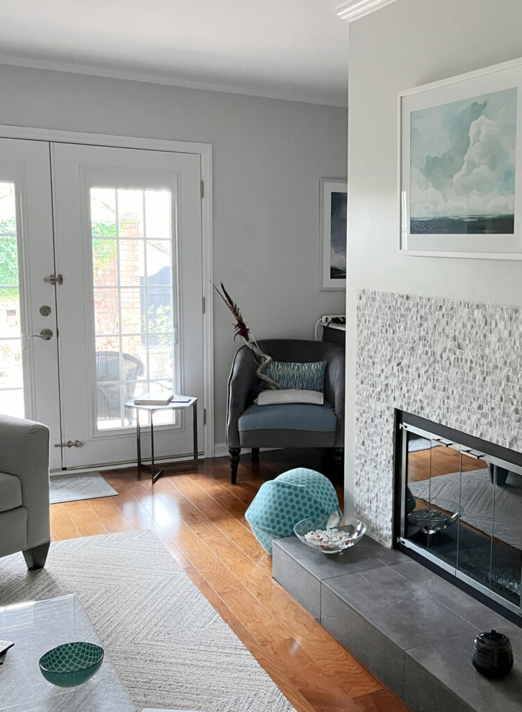 Sherwin Williams Fleur de Sel off white gray with blue-green undertones, orange wood floor, stone gas fireplace, gray furniture, white trim
