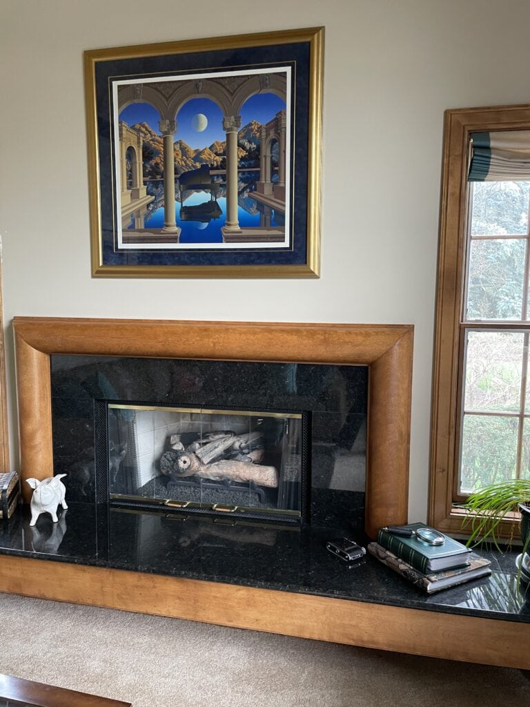 Sherwin Williams Kilim Beige, wood trim gas fireplace, black granite surround, pink beige carpet, wood trim.