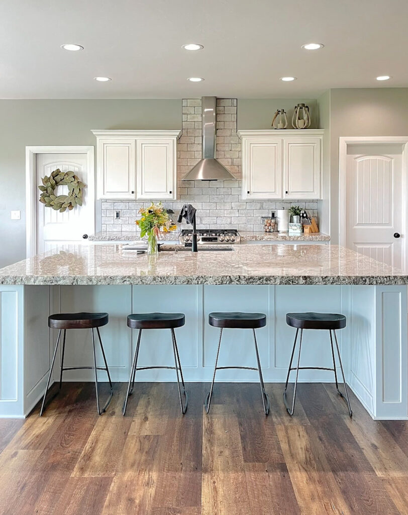 Sherwin Williams Mindful Gray, white kitchen cabinets, granite countertop, wood look tile floor
