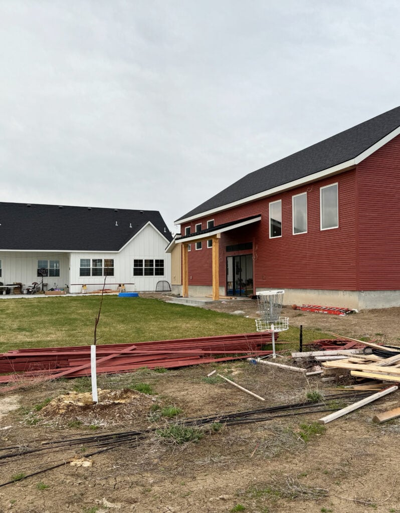 herwin Williams Old Red Barn painted siding, White Hardi on main house and dark charcoal black asphalt roof