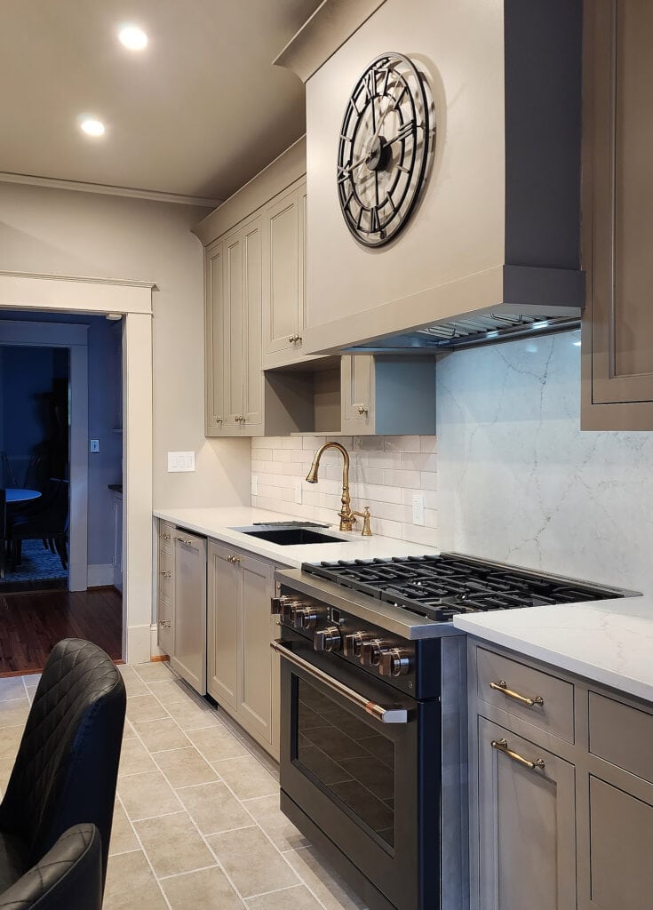 Sherwin Williams Patience, beige cream trim, mushroom greige taupe painted kitchen cabinets, Cambria Ridgegate quartz countertop, Ge Cafe Matte Black range oven, subway tile, beige tile floor 