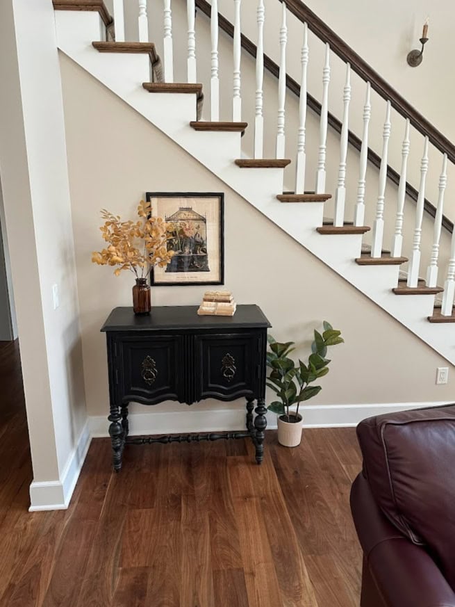Sherwin Williams Rivers Edge best light beige paint color, wood floor, wood stairs with white spindles and wood handrailing. Kylie M Edesign