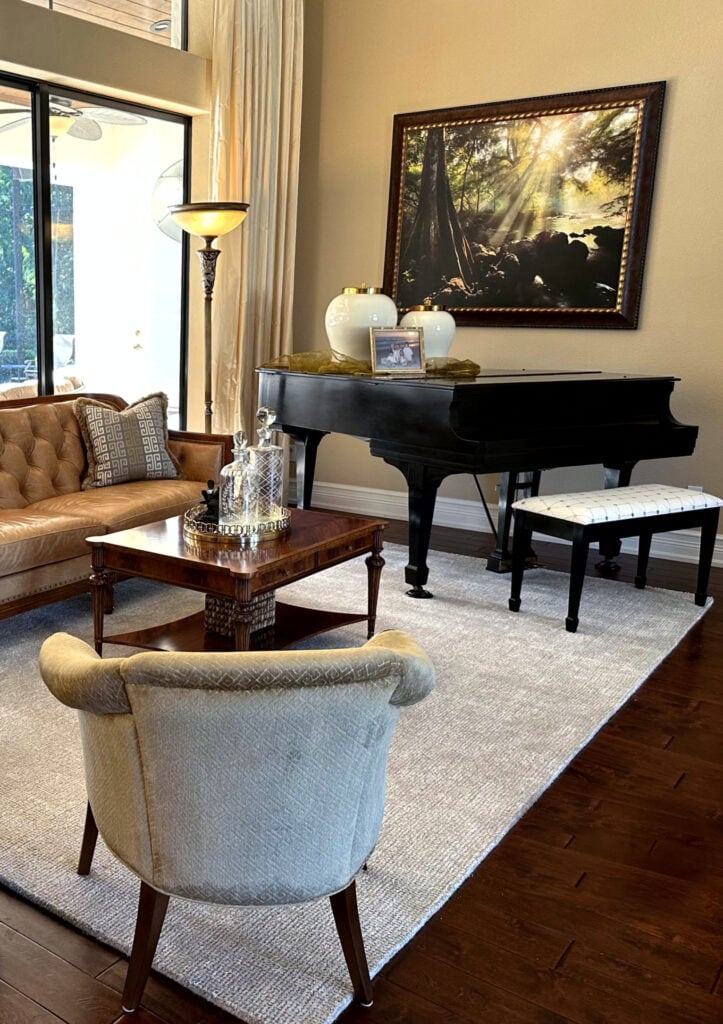 Sherwin Williams Rowhouse Tan, warm golden cream beige color. Living room, traditional, Greek Villa trim, dark wood flooring. (2)
