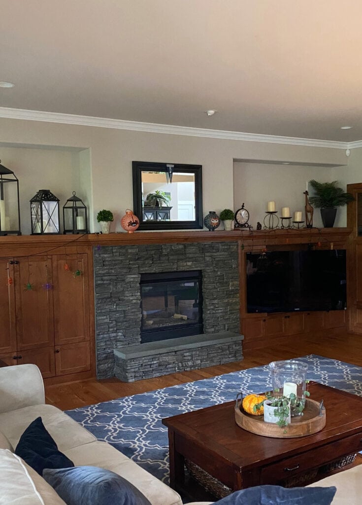 Sherwin Williams Simplify Beige paint color on walls, red stained wood builts ins beside fireplace in family room, Pure White trim