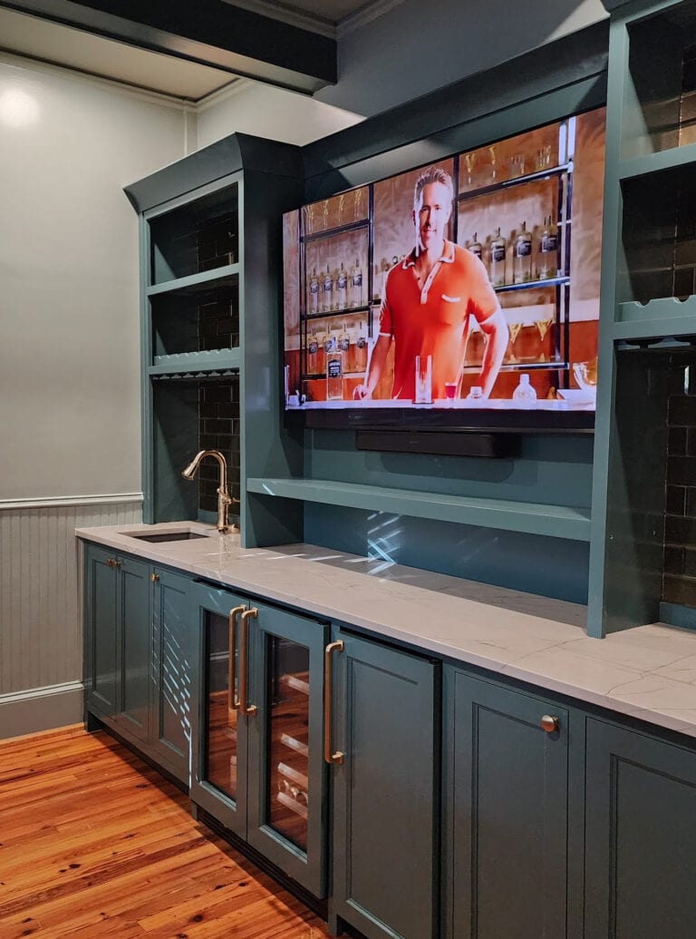 Sherwin Williams Still Water painted blue green teal home bar cabinets, Cambria Ridgegate off-white quartz countertop, Stonybrook green gray on walls, wood floor (1)