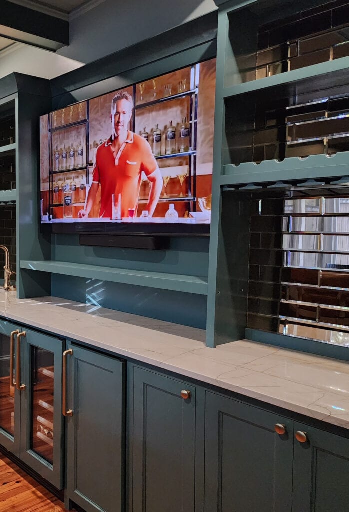 Sherwin Williams Still Water painted blue green teal home bar cabinets, Cambria Ridgegate off-white quartz countertop, mirror subway tile backsplash, Stonybrook green gray on walls, wood floor (2)